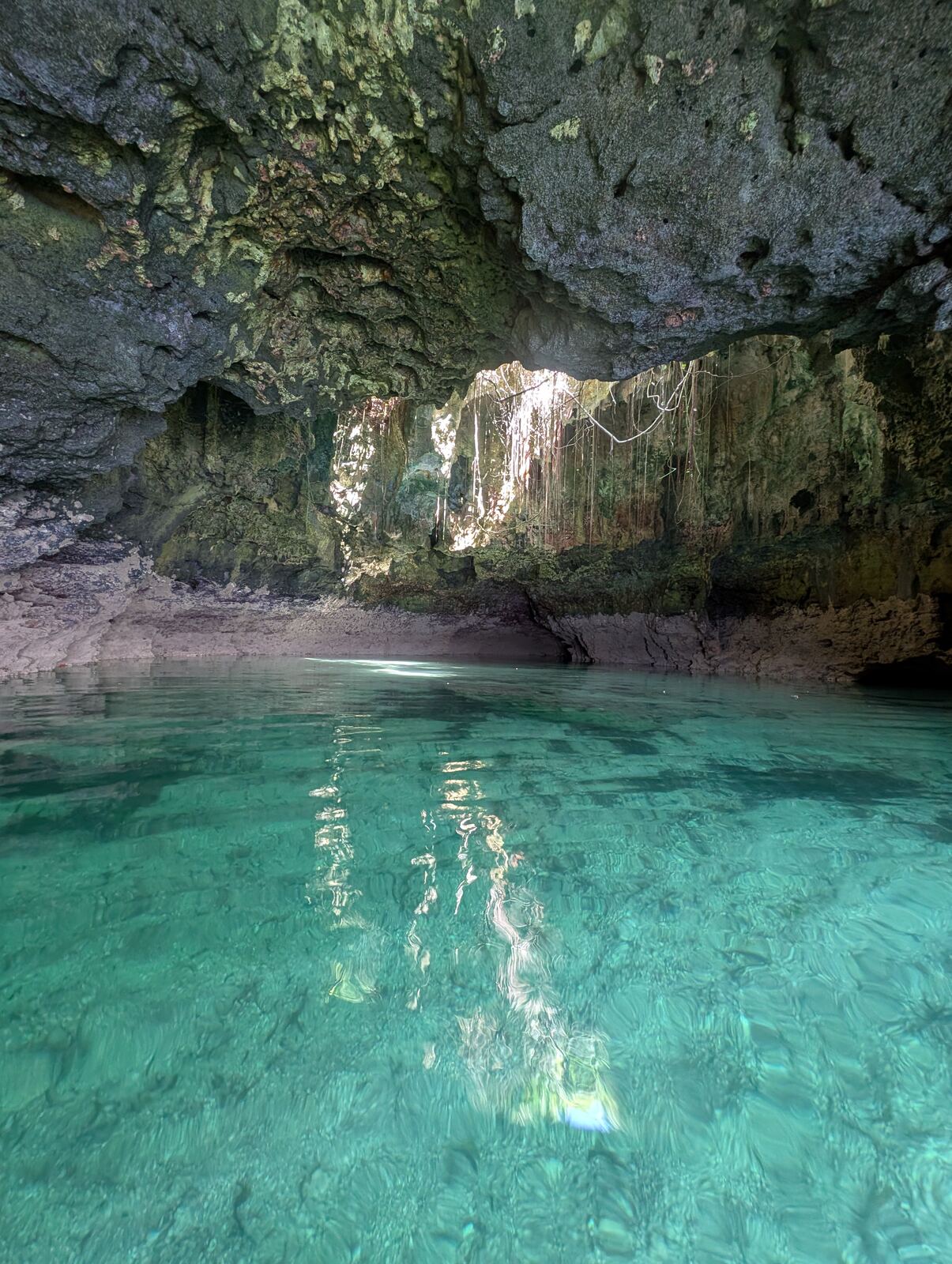 Rocky sea cave filled with clear turquoise water near Diani Beach