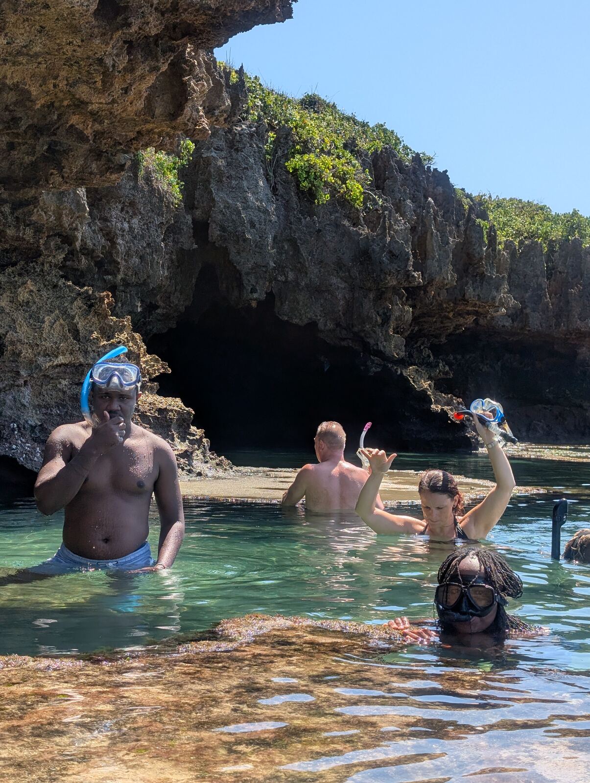 Guests snorkelling inside a rocky sea cave near Diani Beach