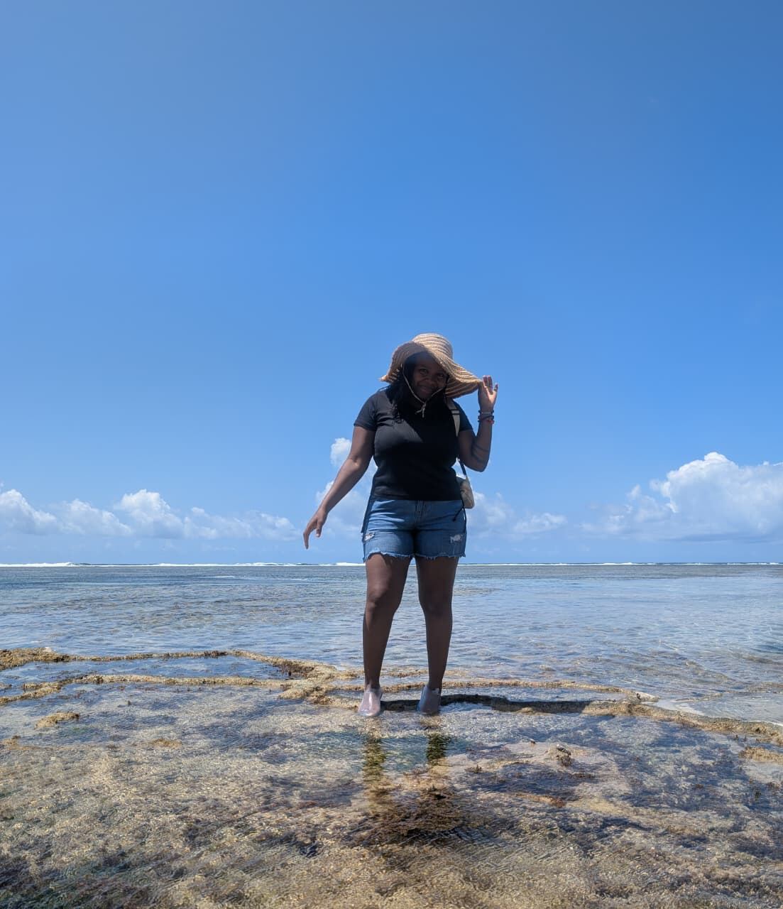 Palm & Tide founder wading across tidal flats near Diani Beach, Kenya
