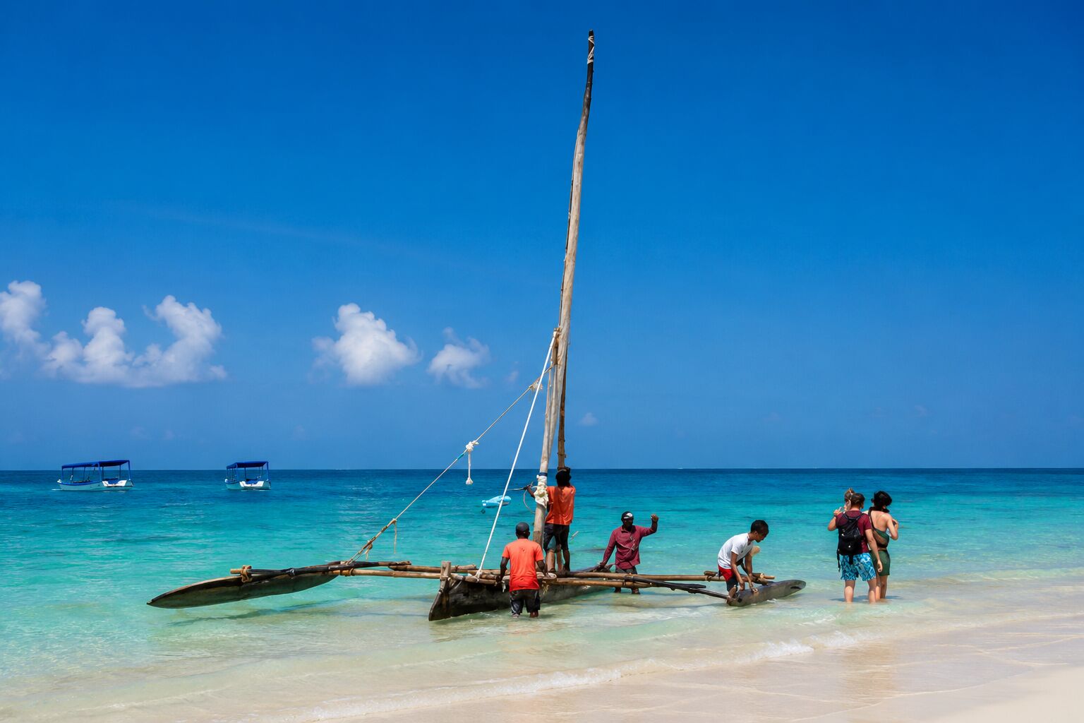Traditional ngalawa boat pulled onto a white-sand beach on Kenya's coast