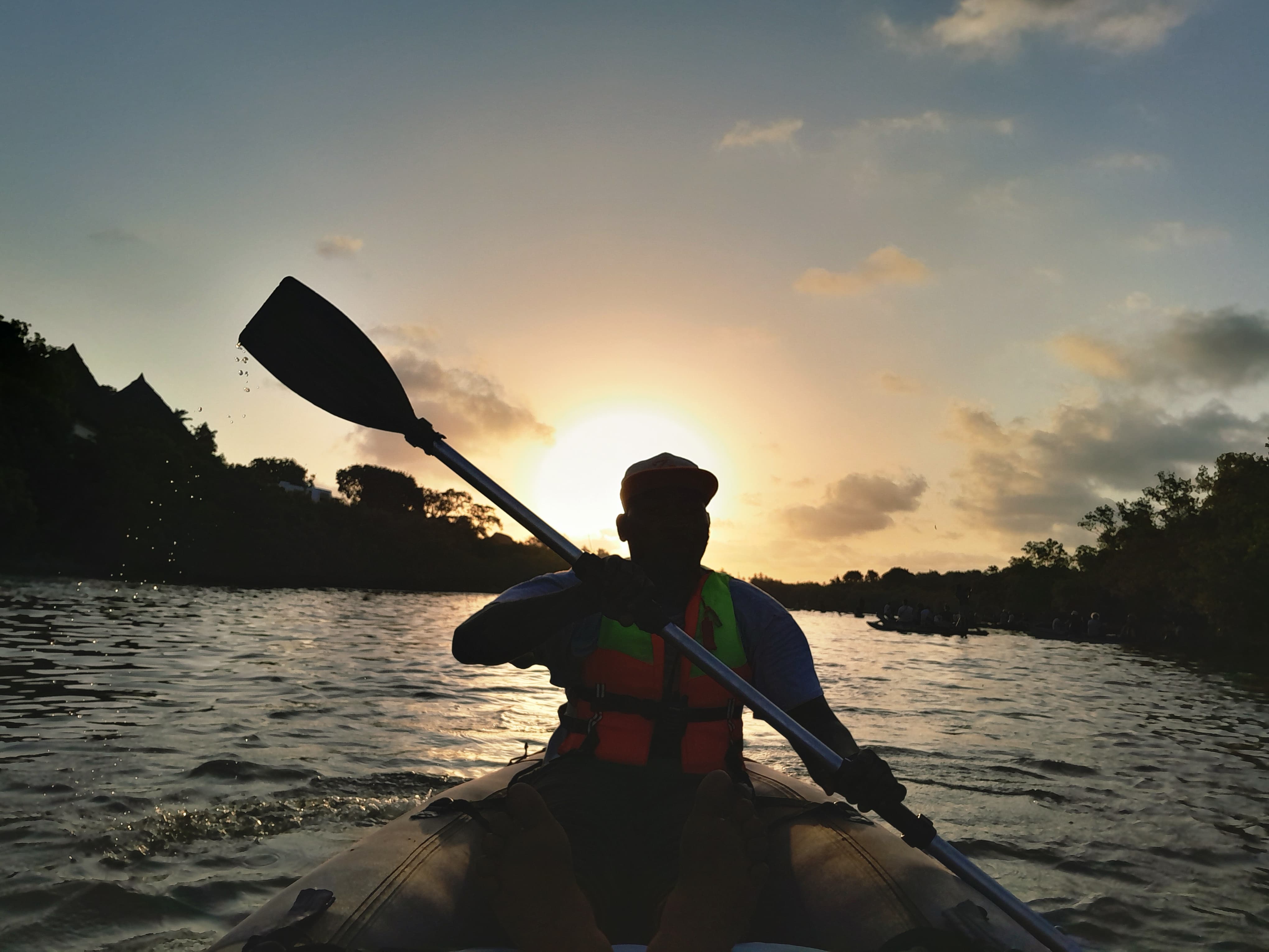 Kayak paddler at sunset on the Kongo River, Diani, Kenya